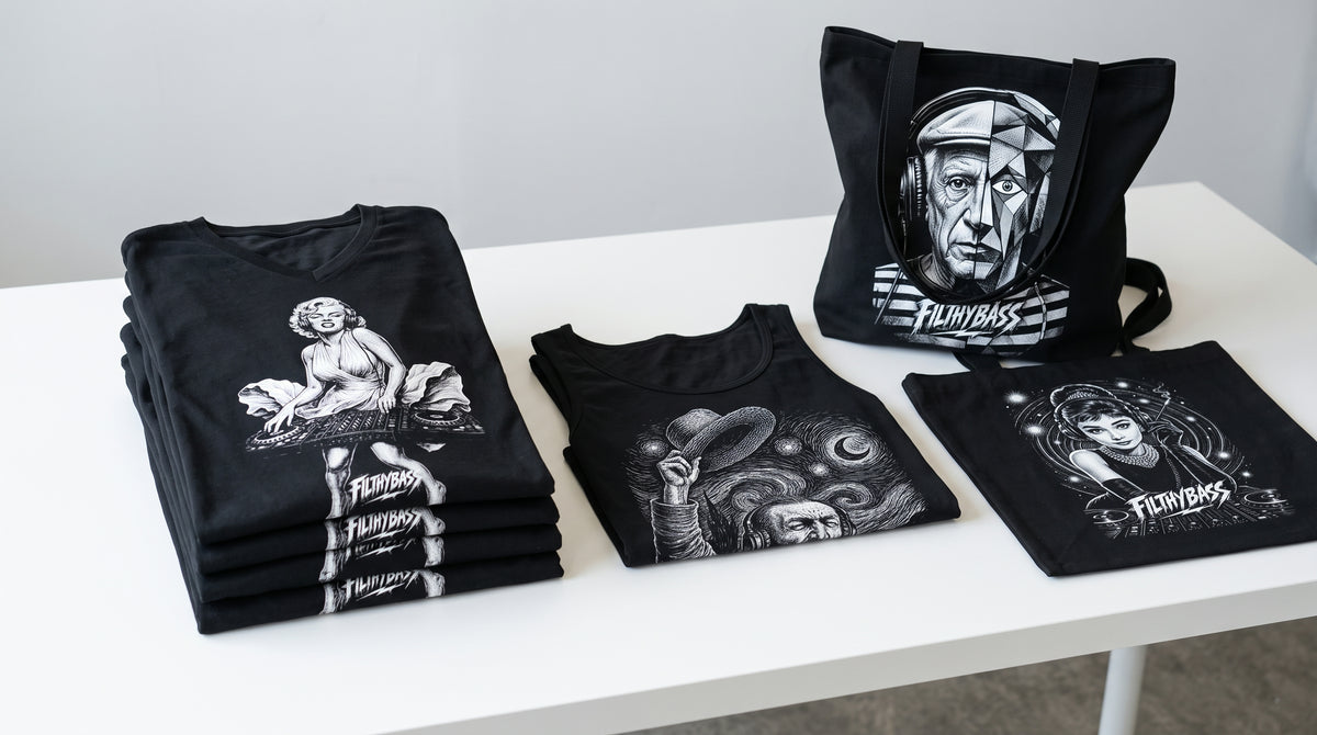 Folded FILTHYBASS V-neck shirts, tank top and tote bags on a white merchandise table